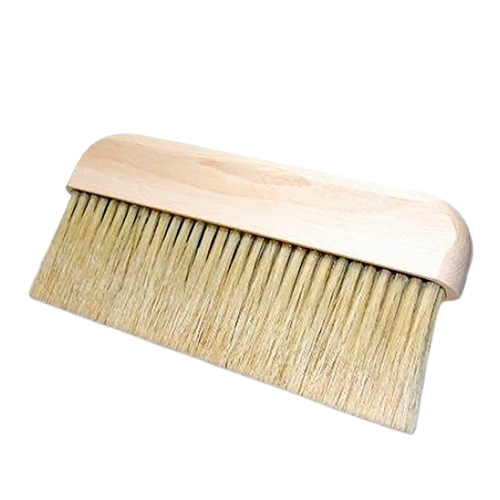 A bristle brush with a wooden handle, used for smoothing wallpaper into place.