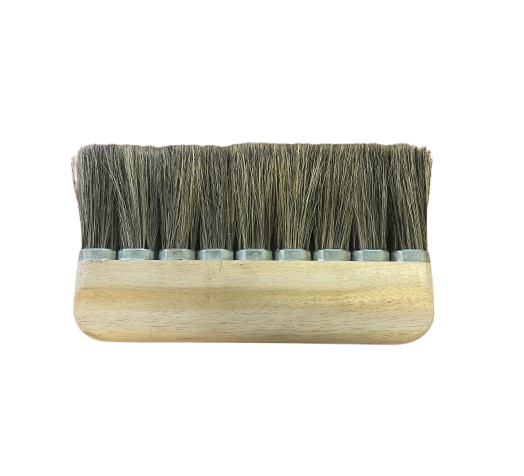 A traditional looking paperhanging brush with natural hog bristles and a wooden body.