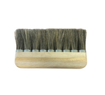A traditional looking paperhanging brush with natural hog bristles and a wooden body.