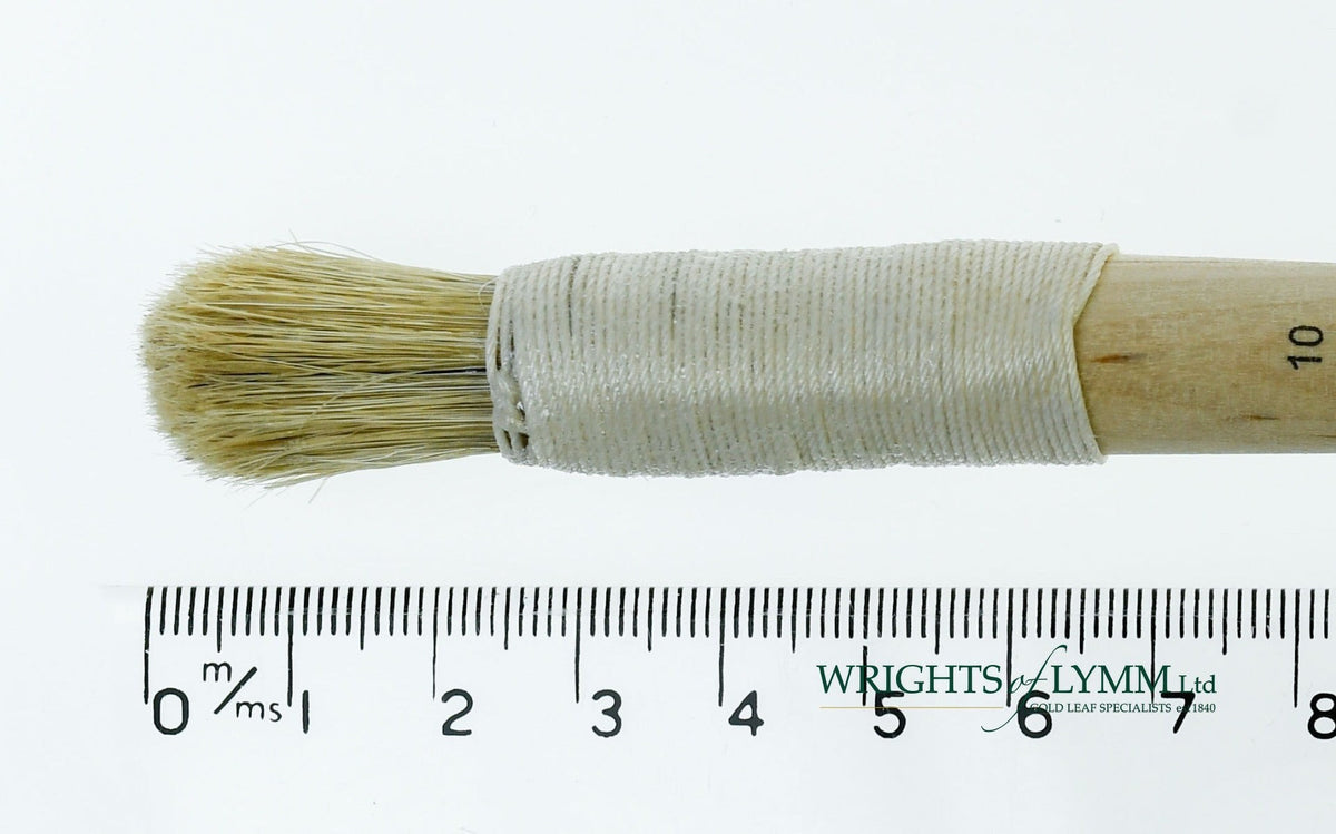 A short, string-bound gesso brush for applying gesso in gilding projects