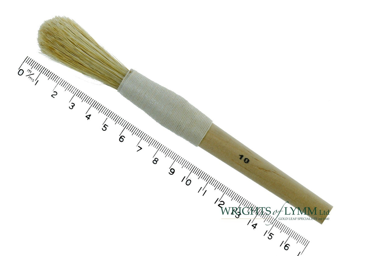 A long, string-bound gesso brush for applying gesso in gilding projects
