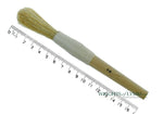 A long, string-bound gesso brush for applying gesso in gilding projects