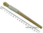 A short, string-bound gesso brush for applying gesso in gilding projects