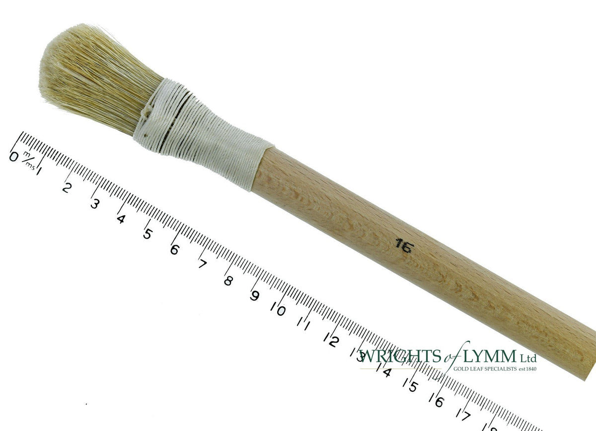 A short, string-bound gesso brush for applying gesso in gilding projects
