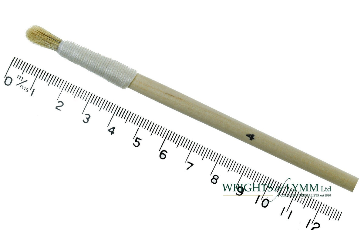 A short, string-bound gesso brush for applying gesso in gilding projects