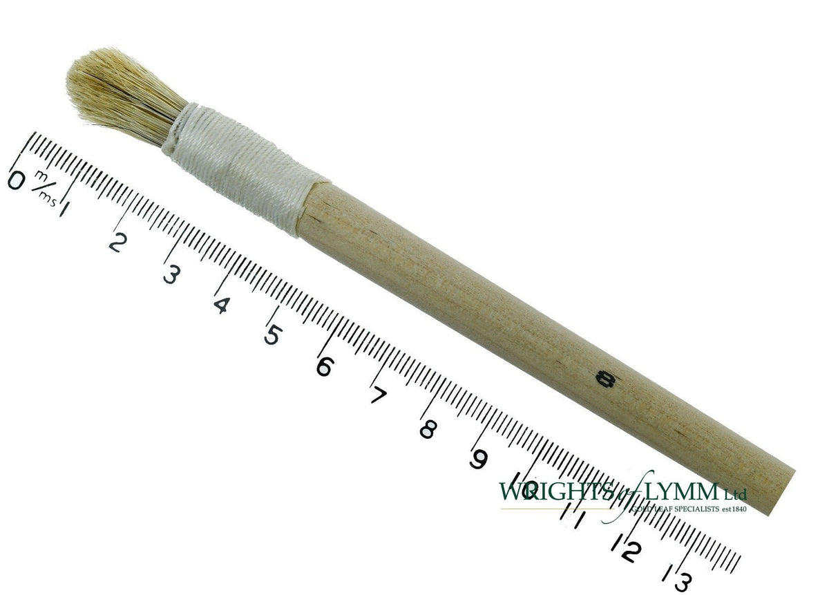 A short, string-bound gesso brush for applying gesso in gilding projects