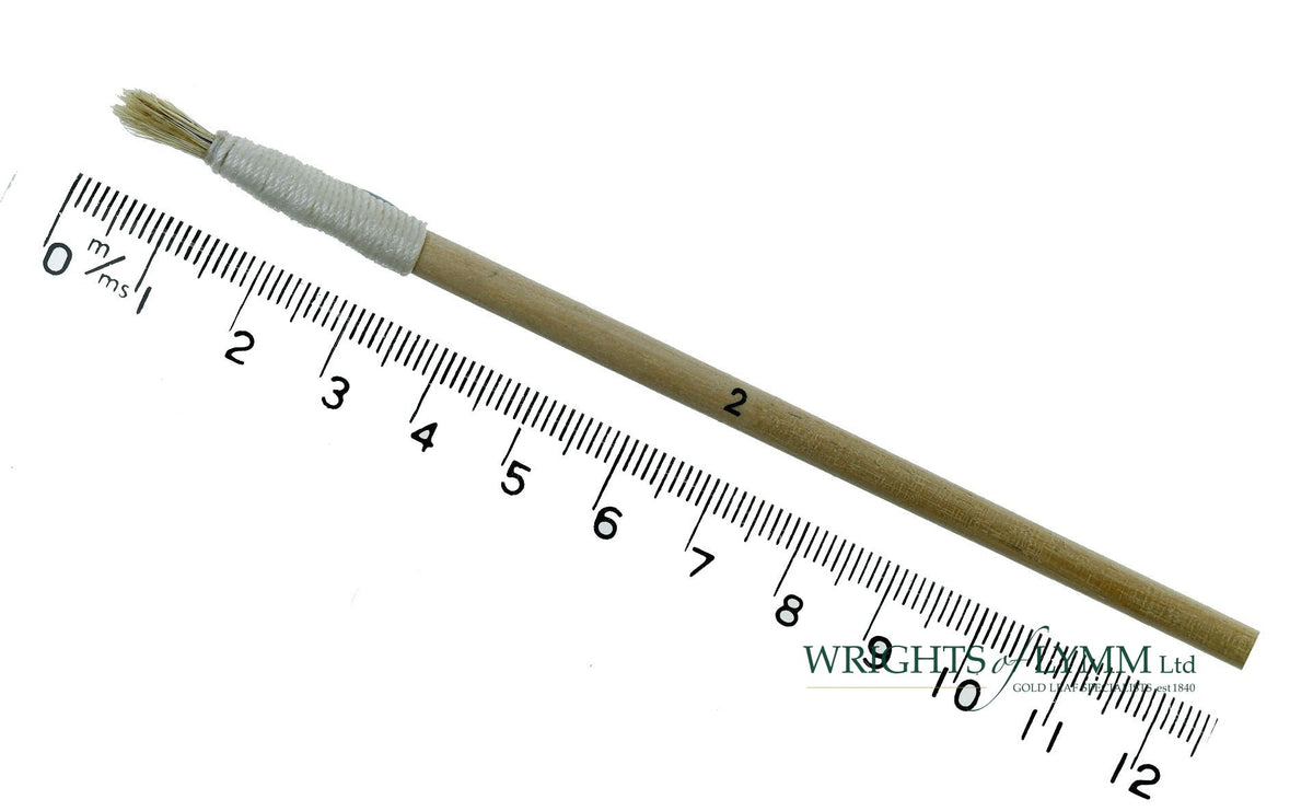 A short, string-bound gesso brush for applying gesso in gilding projects