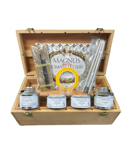 Wooden gift box with paints, a book titled 'Magnus' and brushes